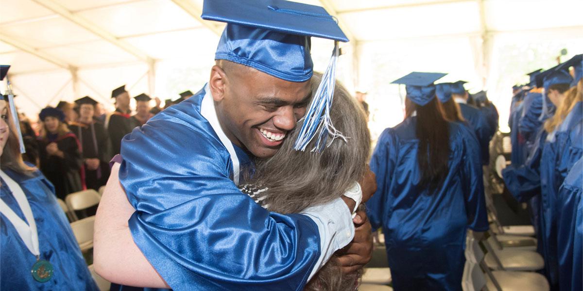 AACC graduate hugging his mom.